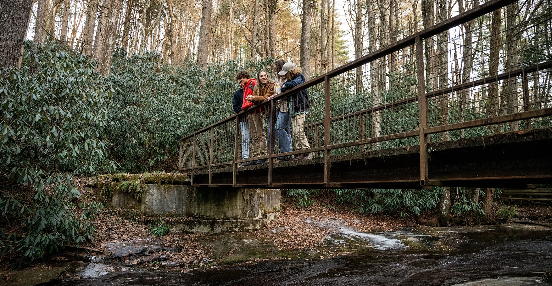 a group of people standing on a bridge