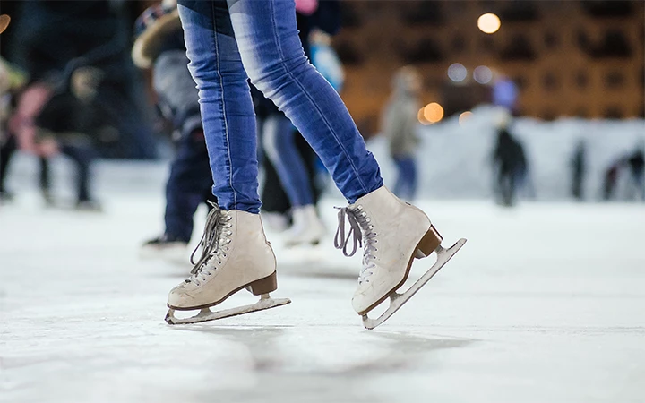 a person's legs wearing ice skates