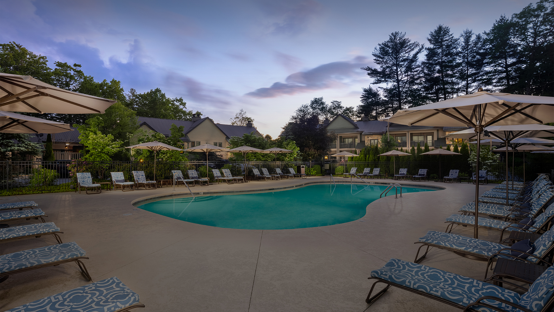 a pool with chairs and umbrellas
