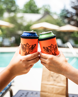 two hands holding up cans