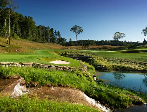 a golf course with a small waterfall