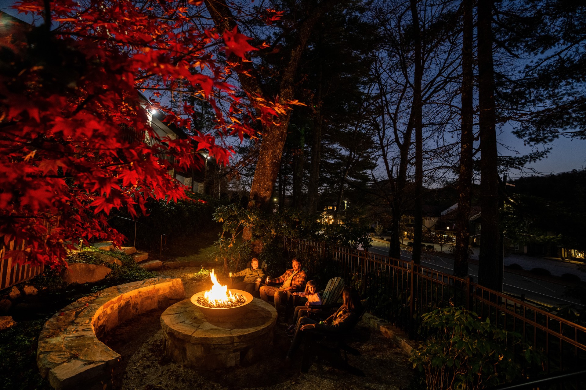 a group of people sitting around a fire pit