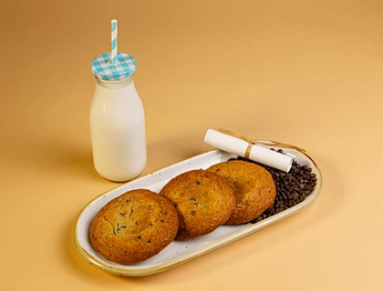 a tray of cookies and a bottle of milk