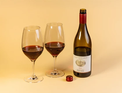 a bottle and two wine glasses