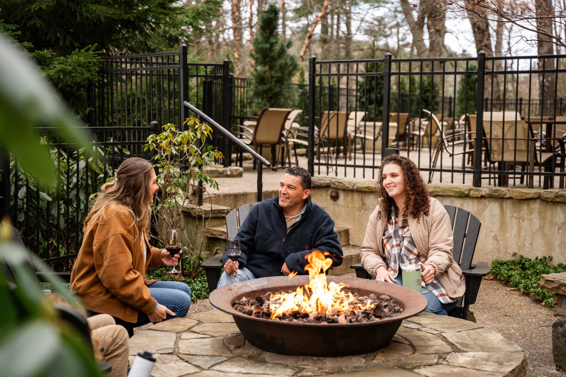 a group of people sitting around a fire pit