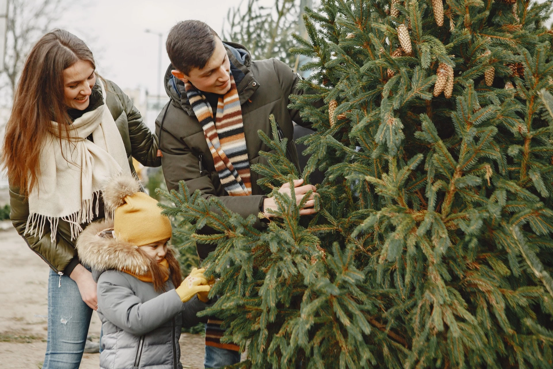 a group of people standing next to a tree