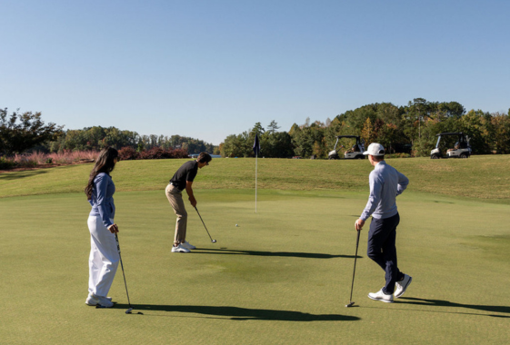 a group of people playing golf