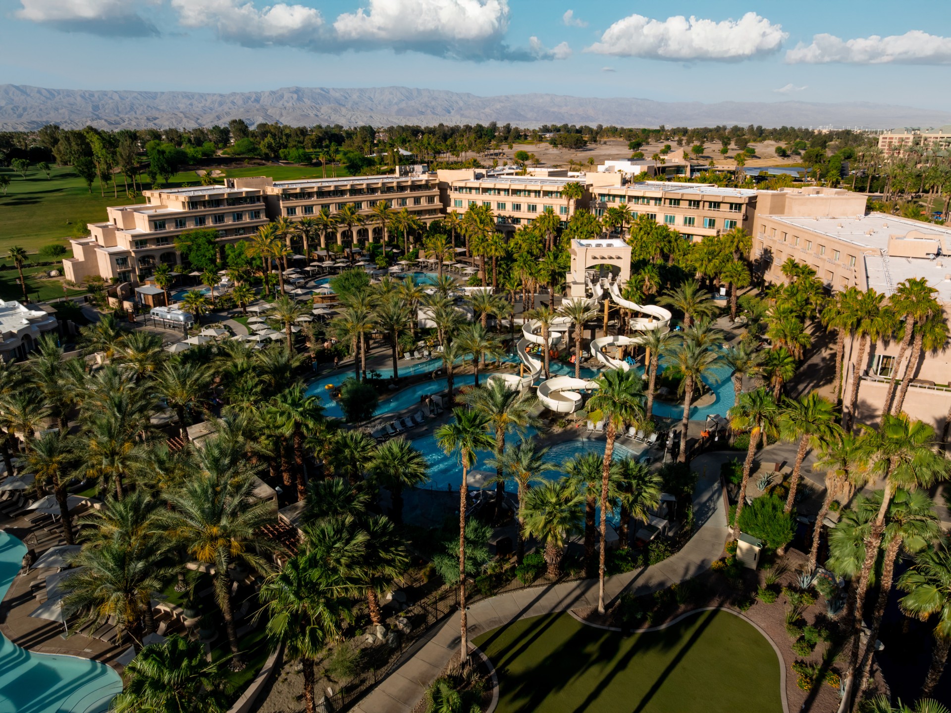 a resort with palm trees and a pool