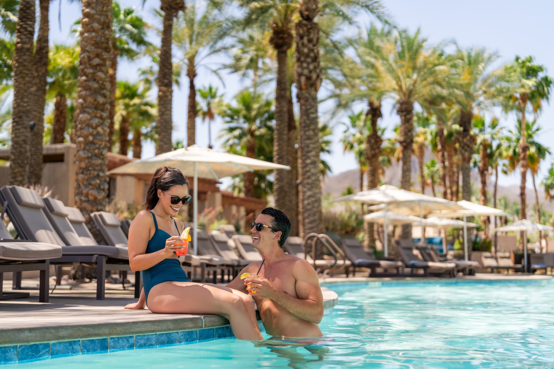 a man and woman sitting in a pool