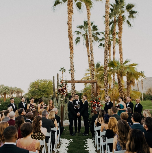 a group of people in front of a wedding ceremony