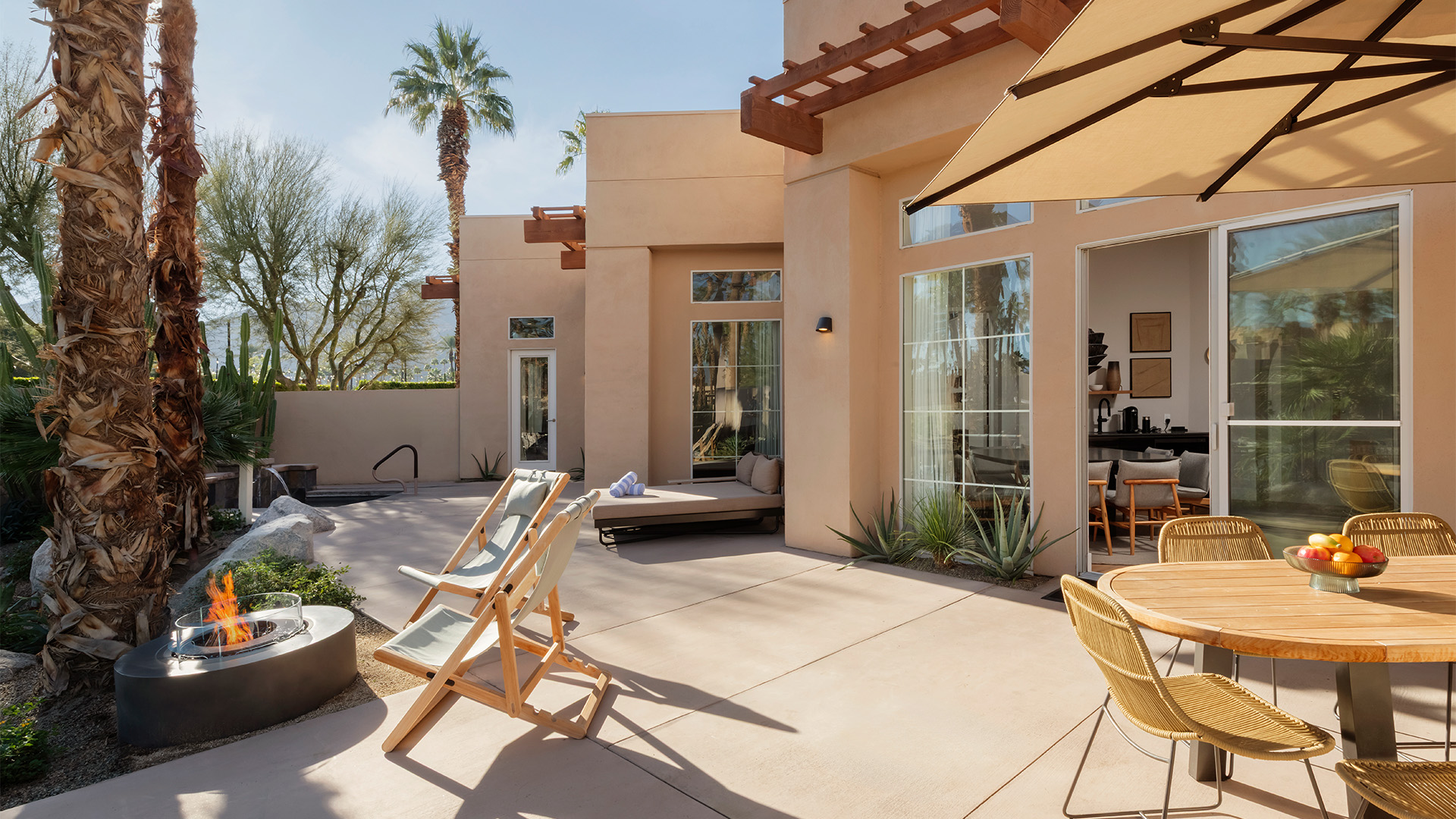 a patio with chairs and a table