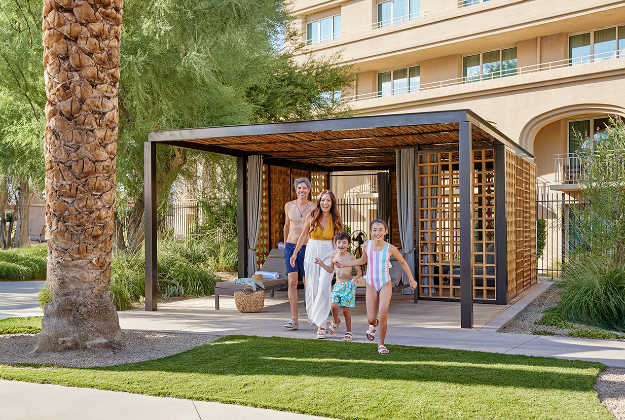 a group of people walking under a covered patio