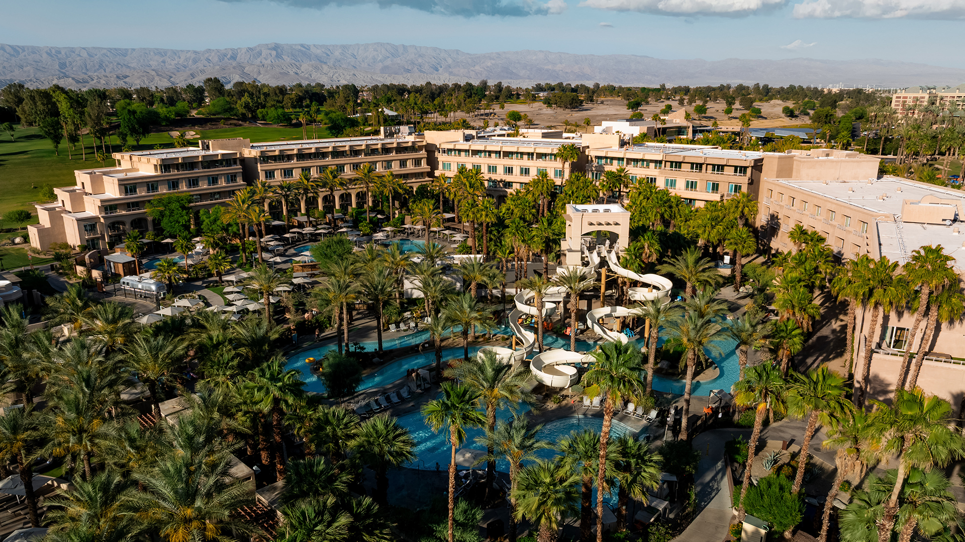 a water park with palm trees and buildings