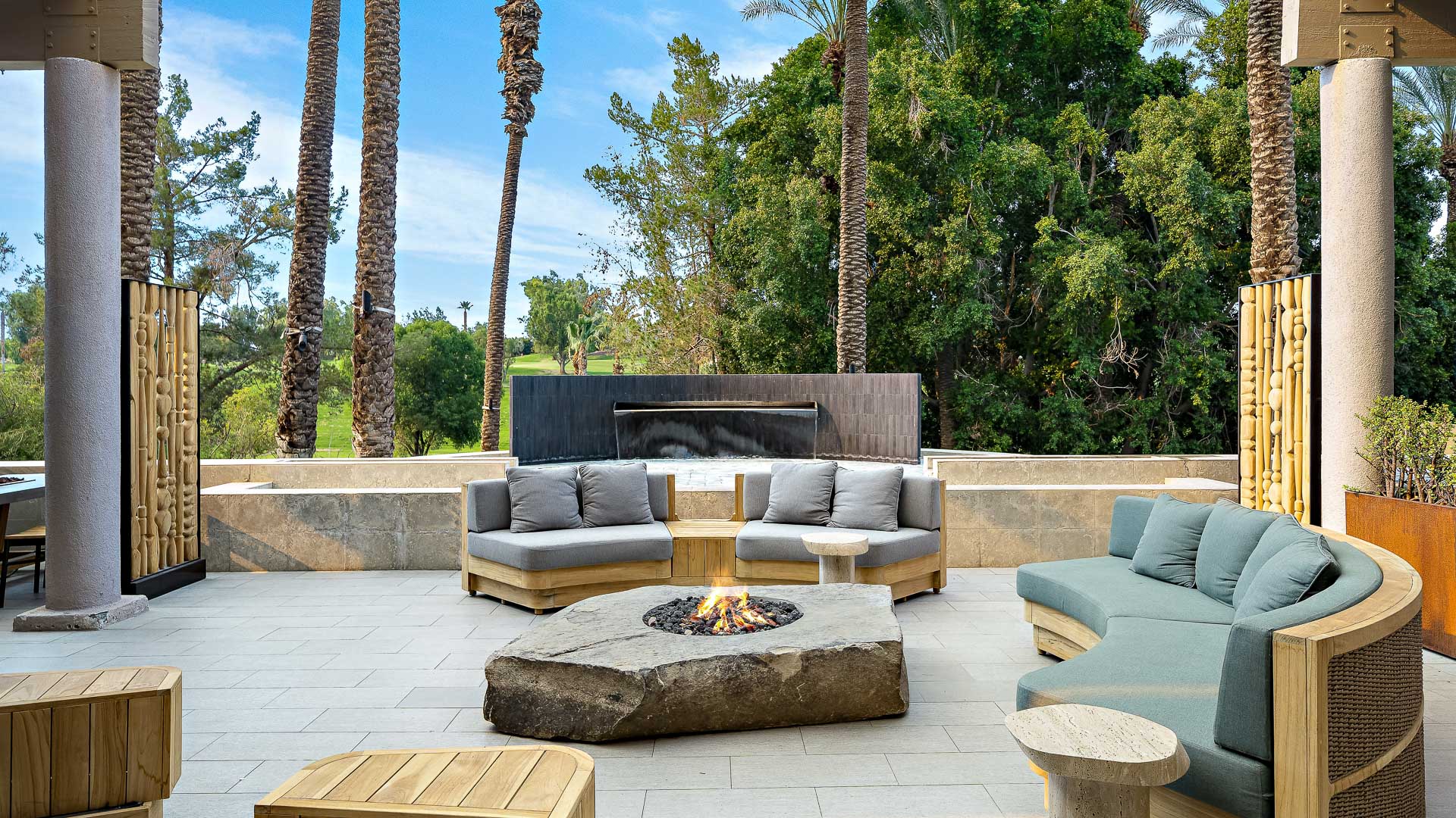 a patio with a fire pit and couches