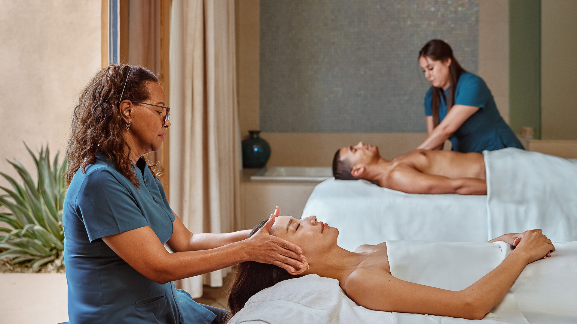 a woman massaging a woman's head