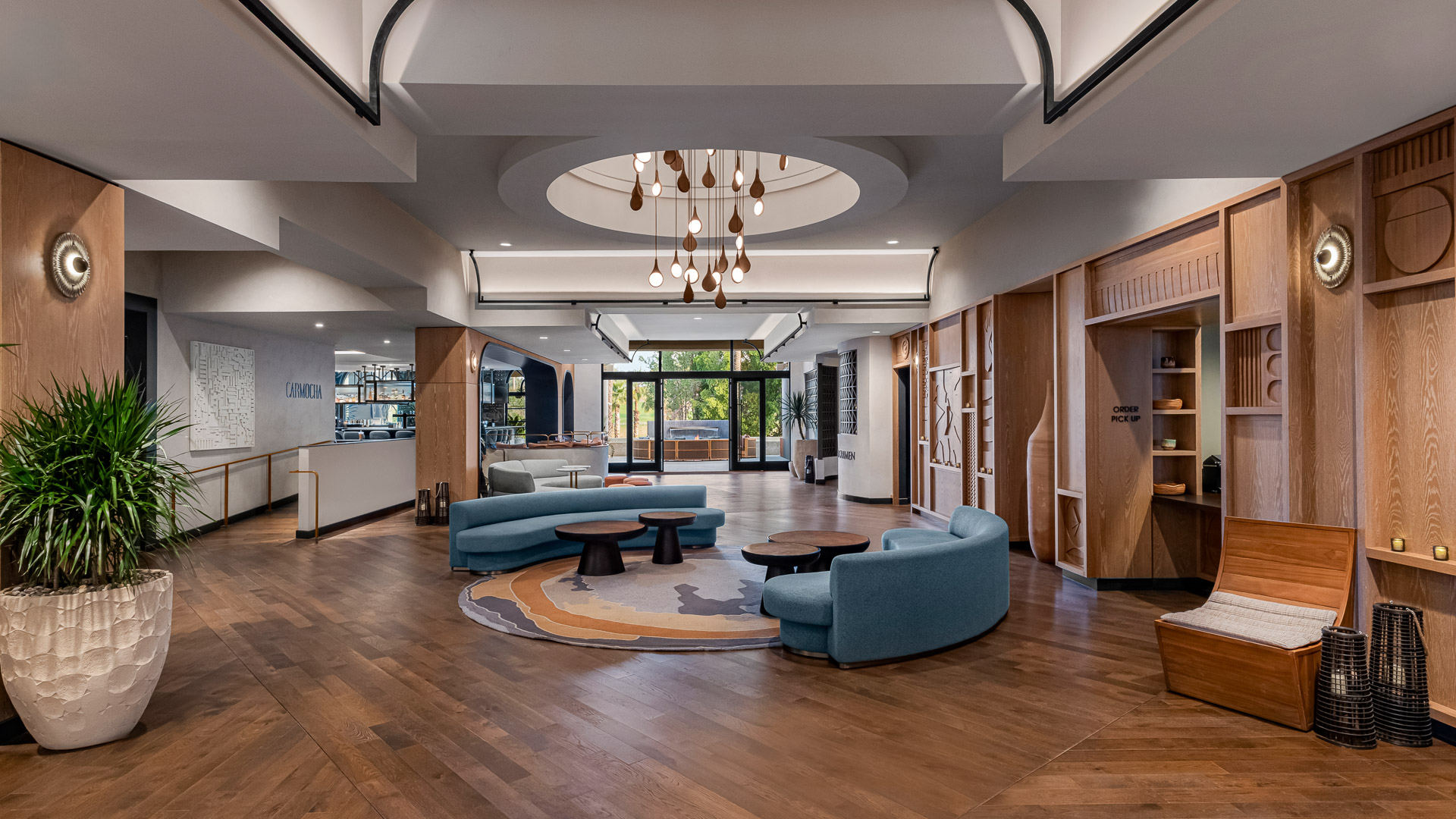 a room with a round area with couches and tables