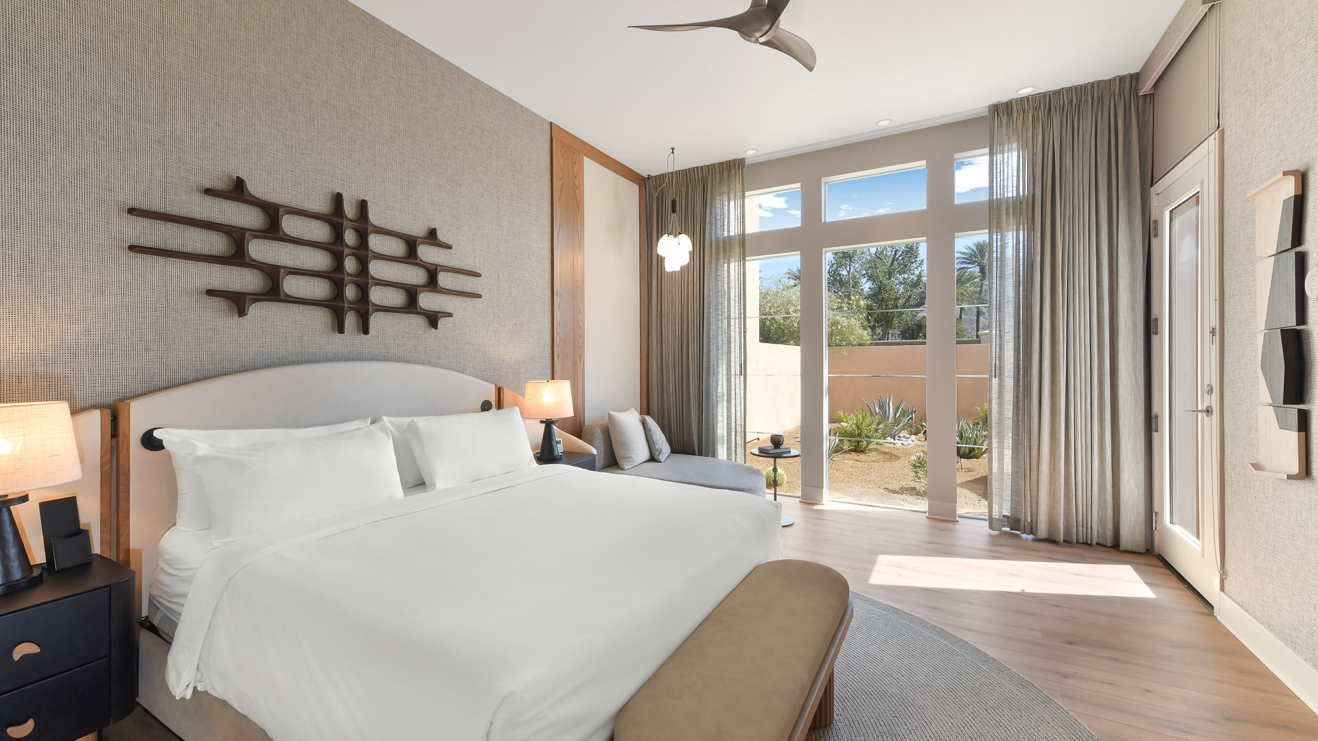 a bedroom with a large bed and a ceiling fan