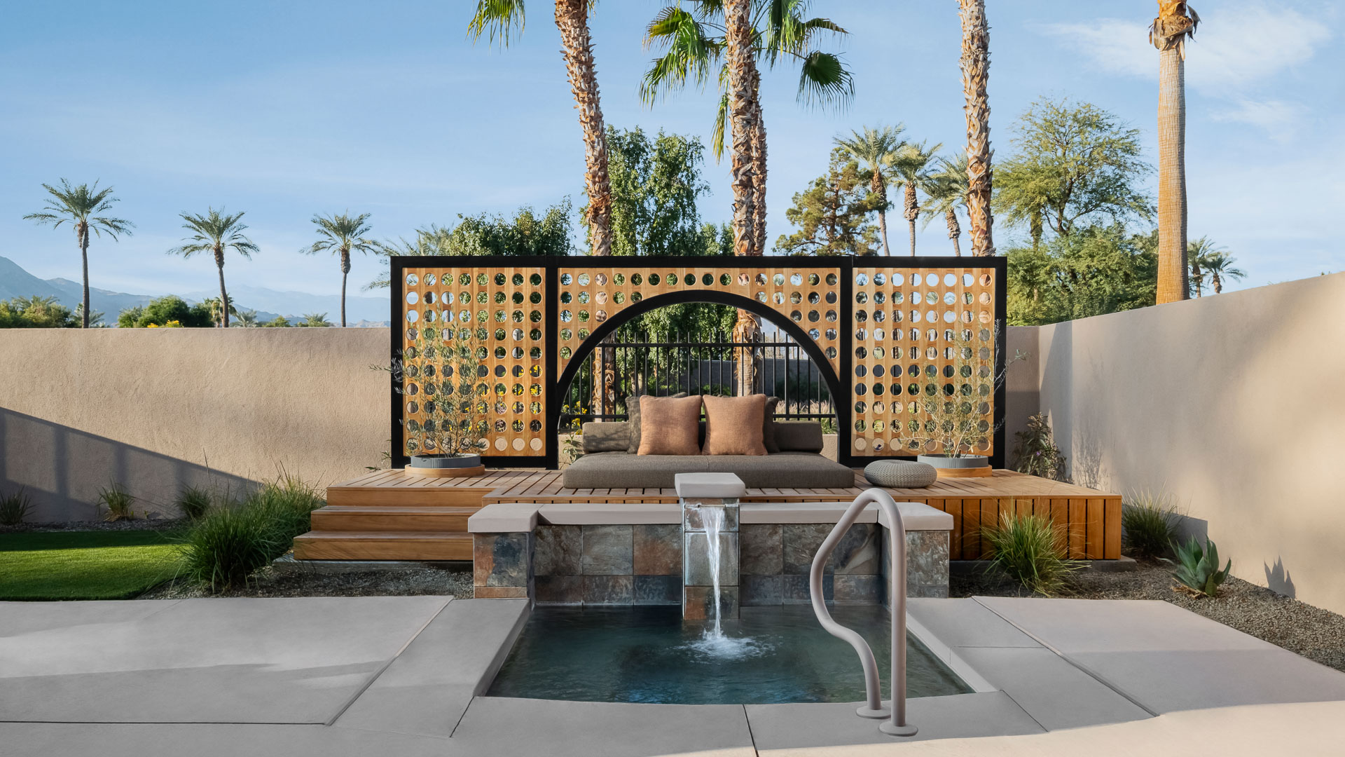 a pool with a bench and a screen with a wood deck and palm trees