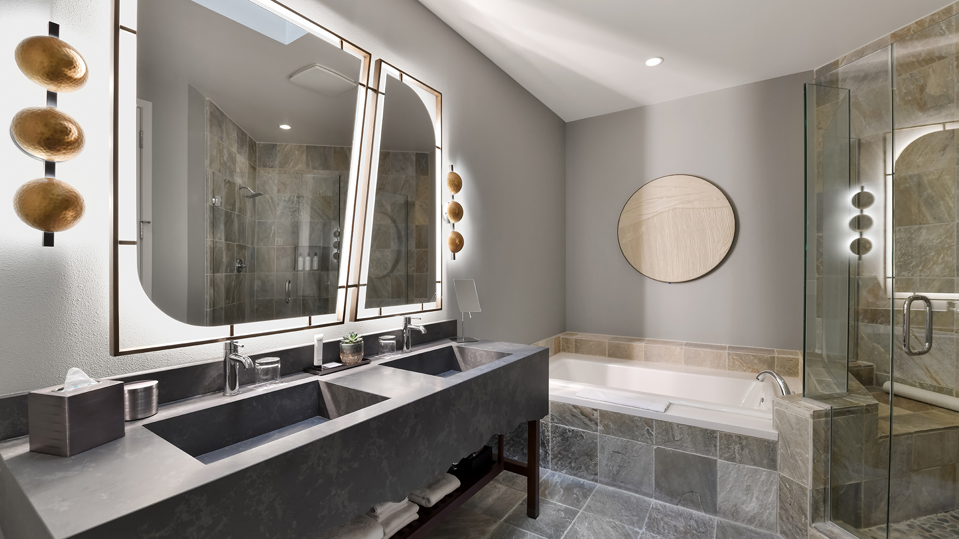 a bathroom with a large mirror and a tub