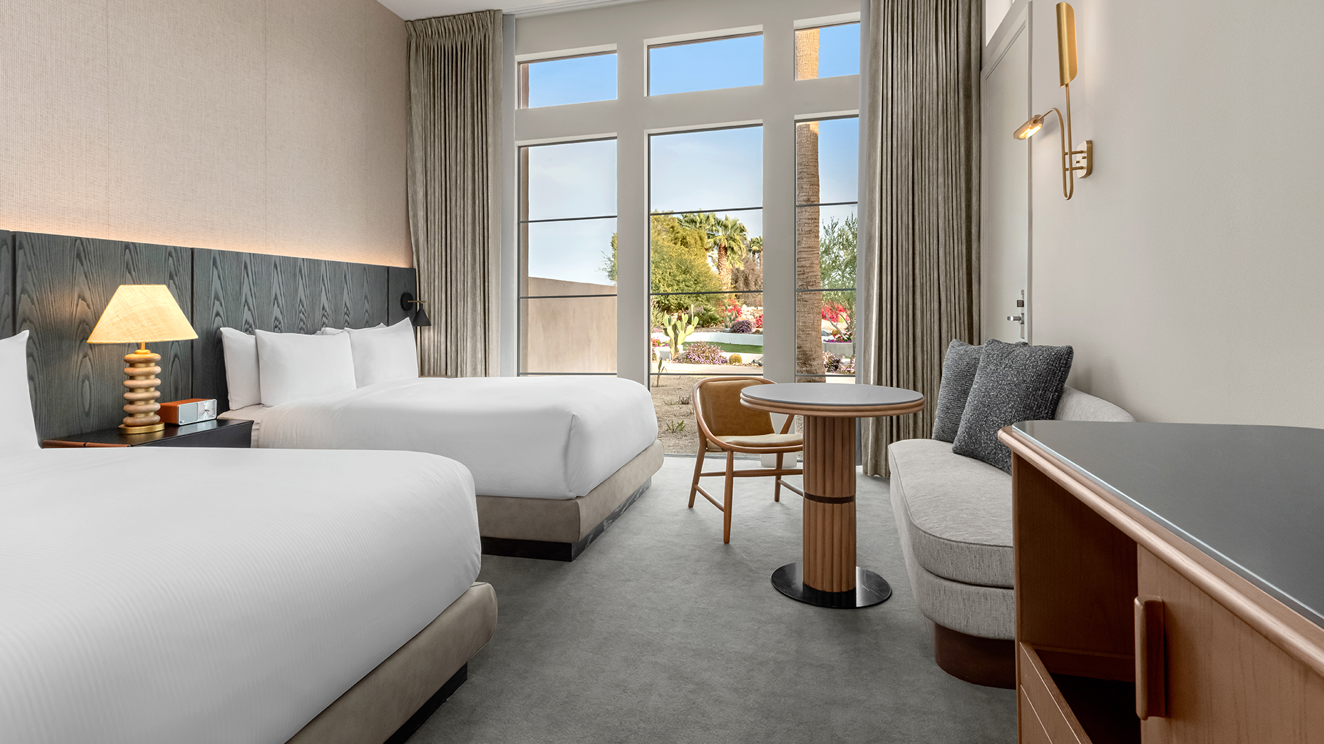 a room with two beds and a table