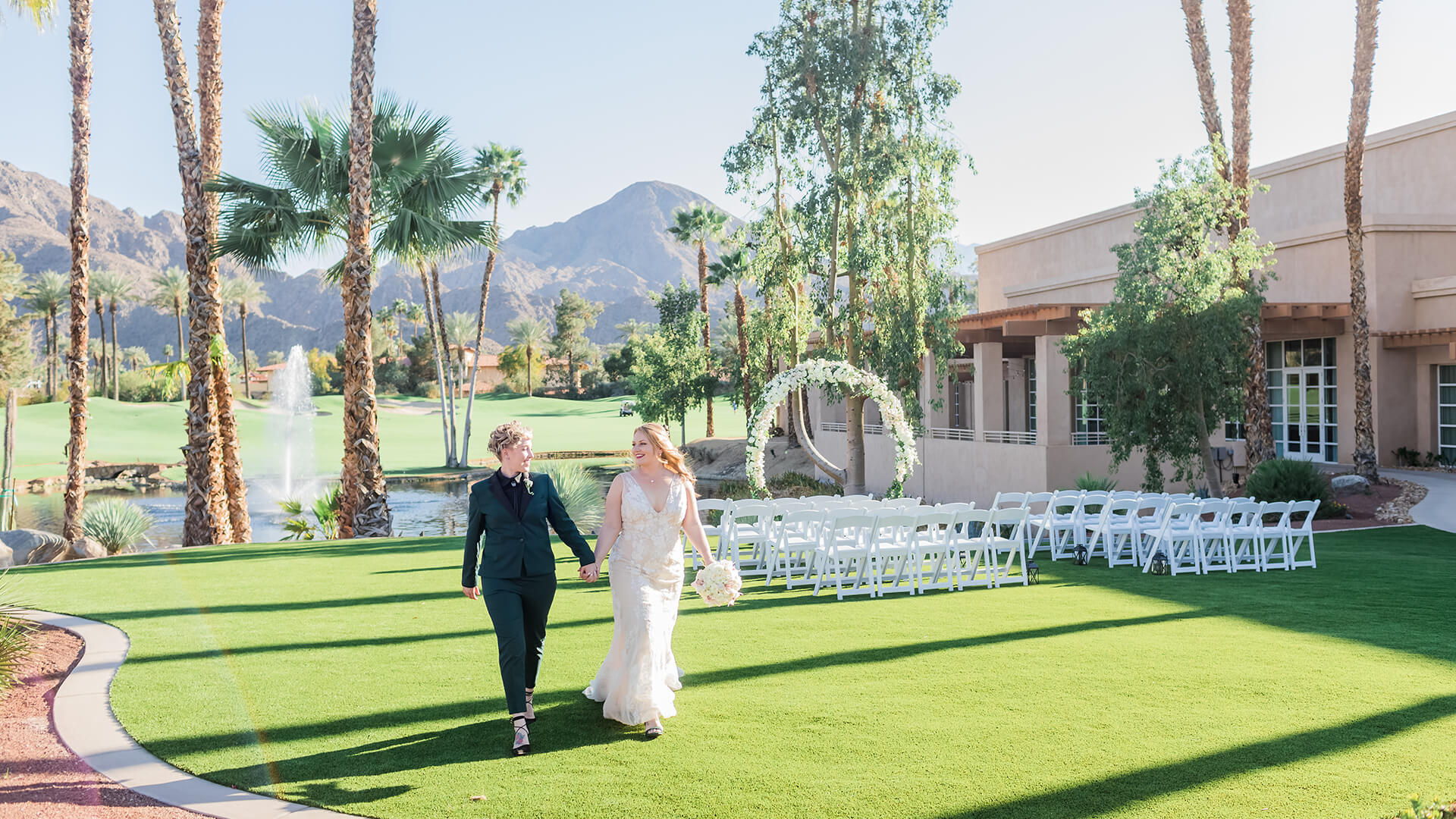 a man and woman walking down a lawn