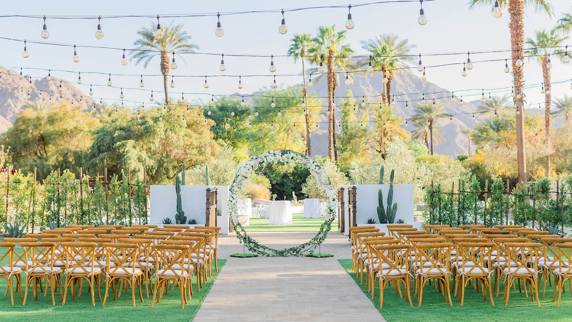 a wedding ceremony with chairs and a circular arch