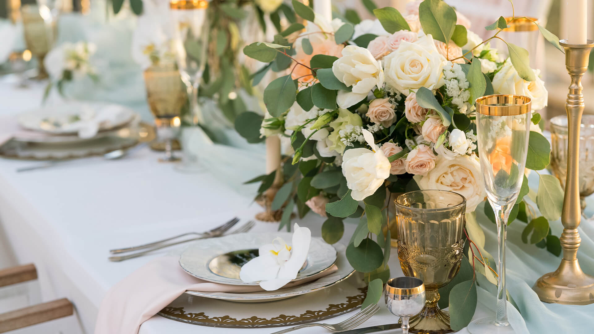 a table set with flowers and glasses