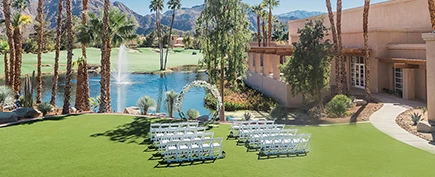 a group of white chairs in a grassy area