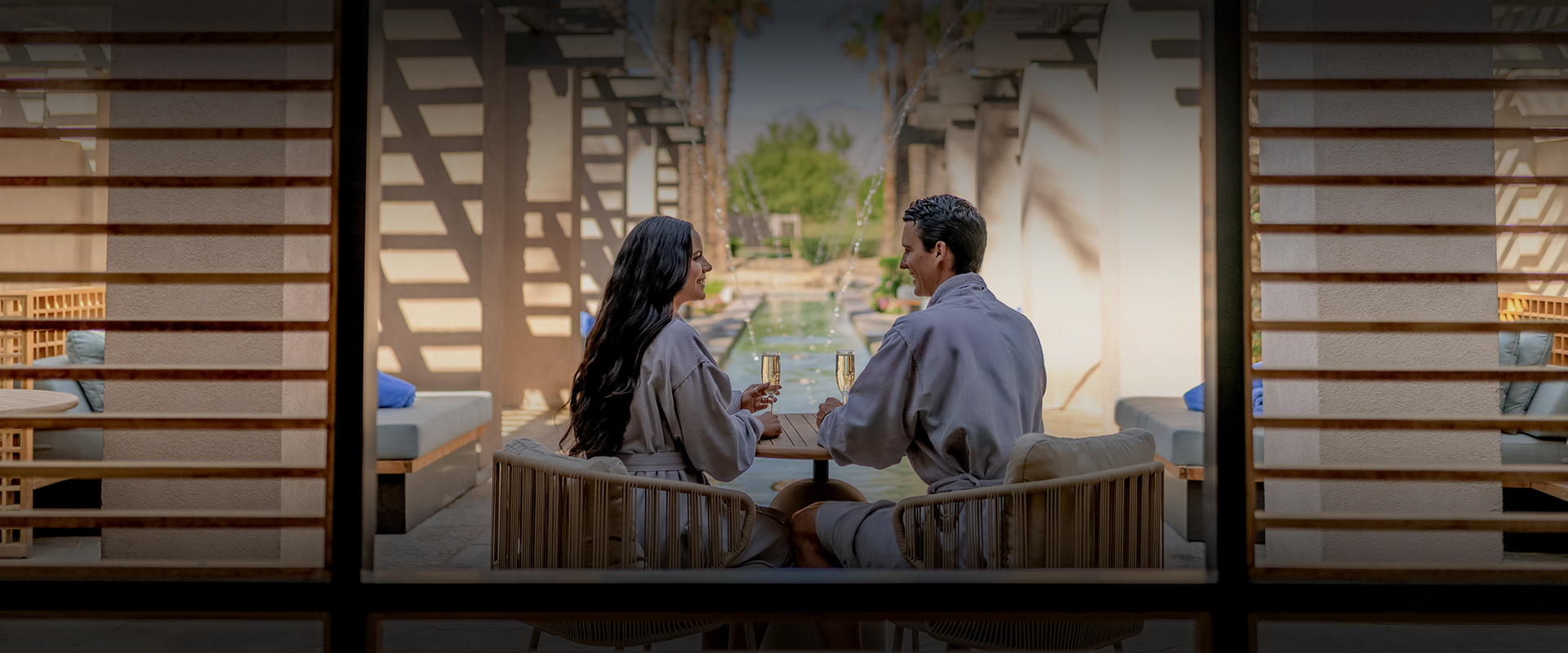 a man and woman sitting at a table with drinks