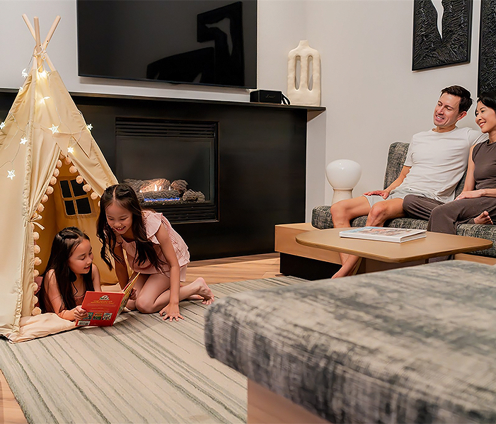 a man and two girls sitting in a living room