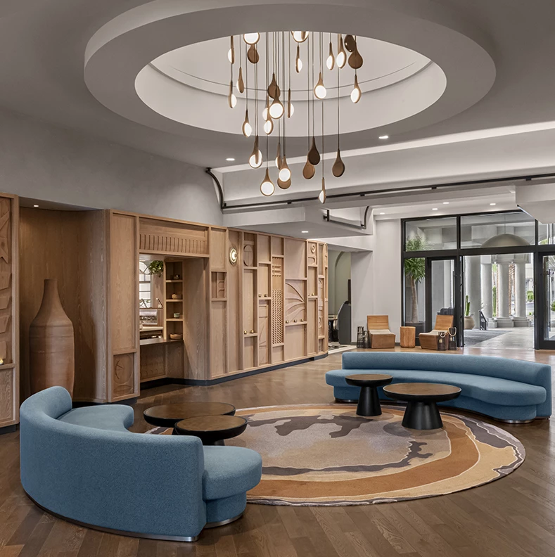 a room with a round rug and couches