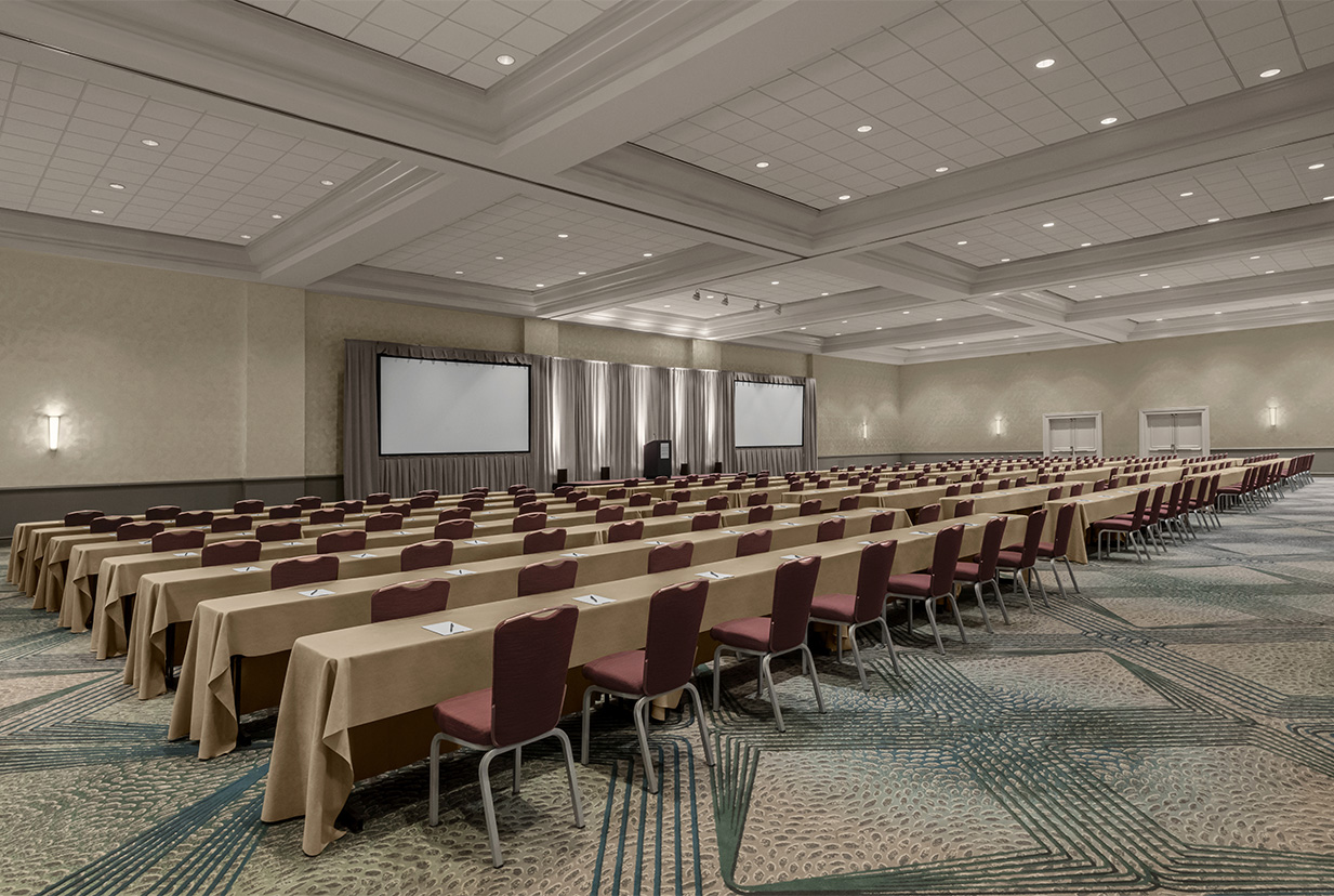 a room with long tables and chairs