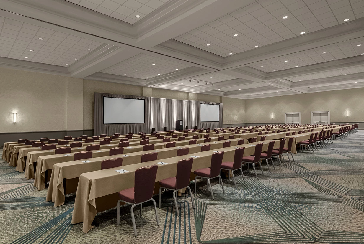 a room with long tables and chairs