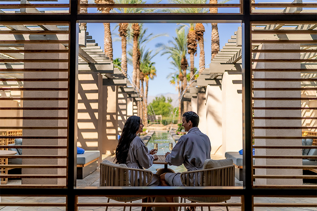 a man and woman sitting at a table with drinks