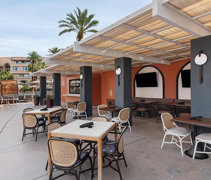 a patio with tables and chairs