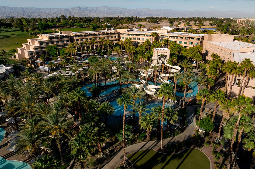 a water park with palm trees and buildings