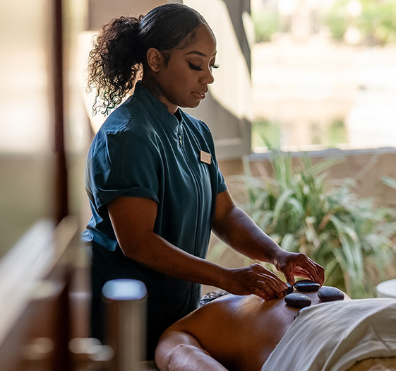 a woman massaging a woman's back