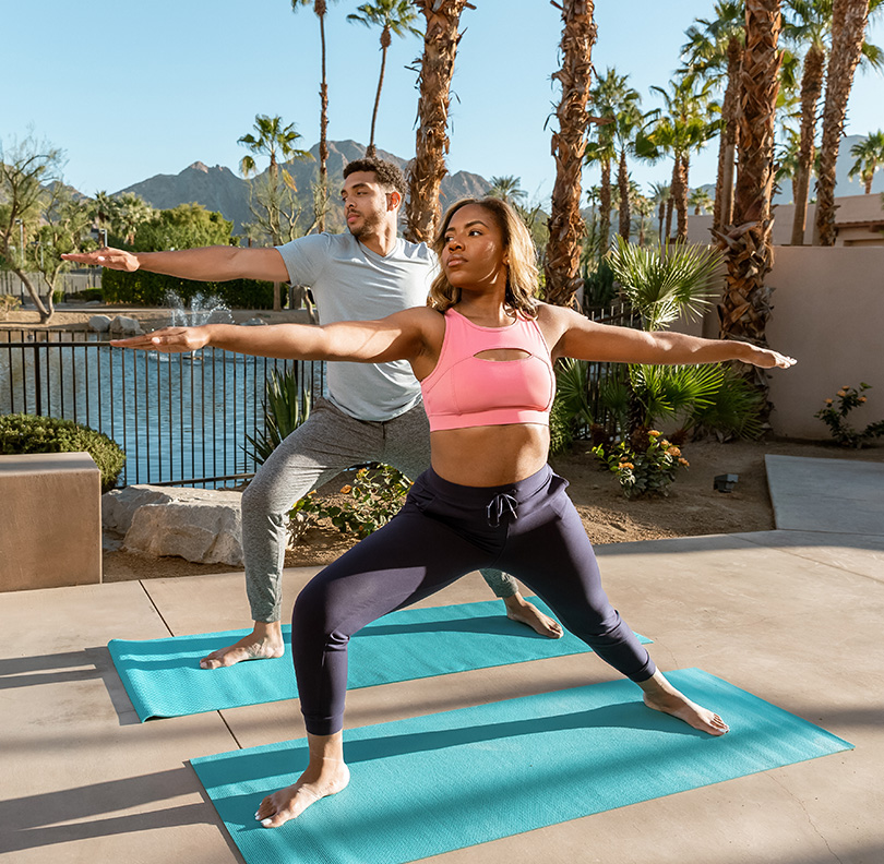 a man and woman doing yoga