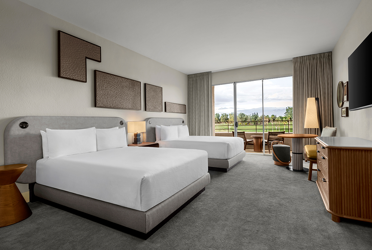 a room with two beds and a table