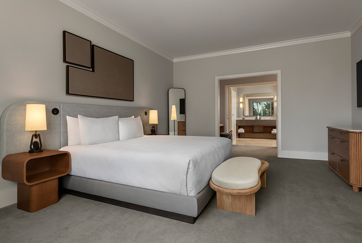 a bedroom with a bed and a bench