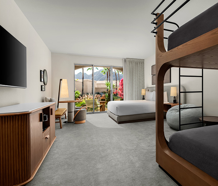 a room with a bed and a television