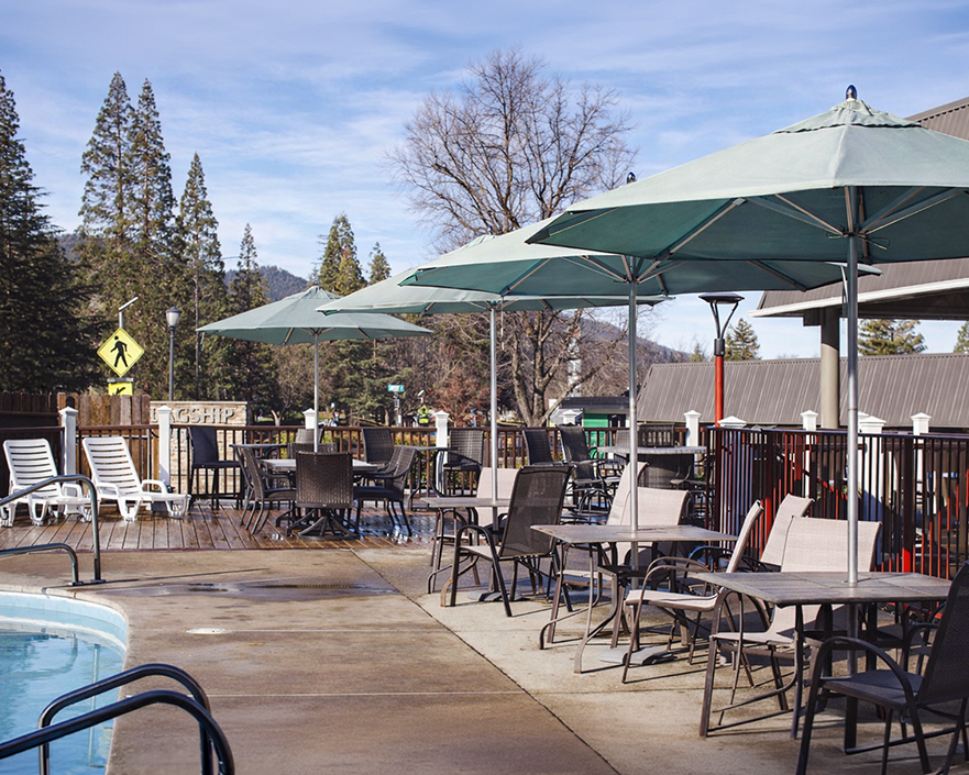 a patio with tables and umbrellas