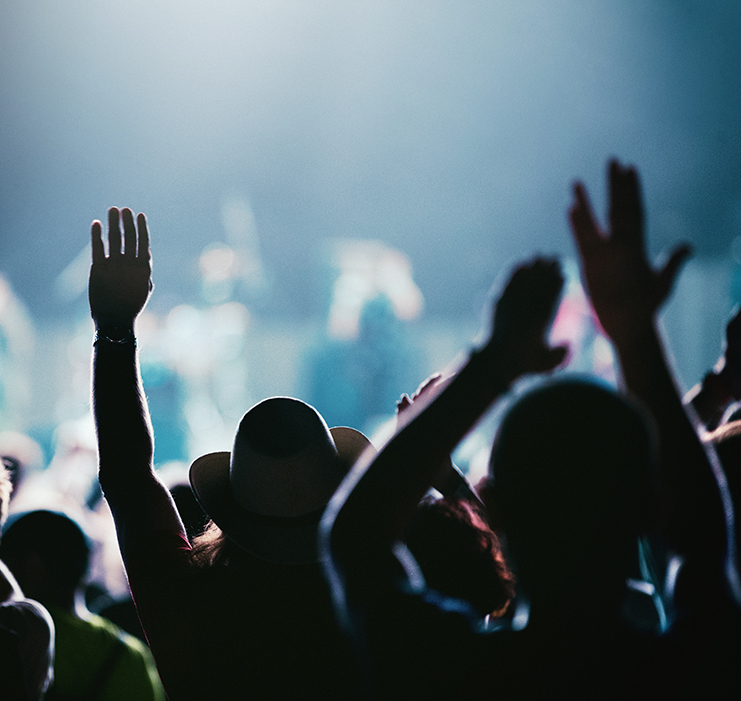 a group of people with their hands up in the air