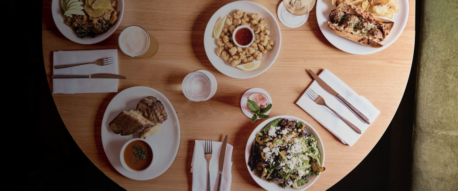 a table with plates of food and glasses of water
