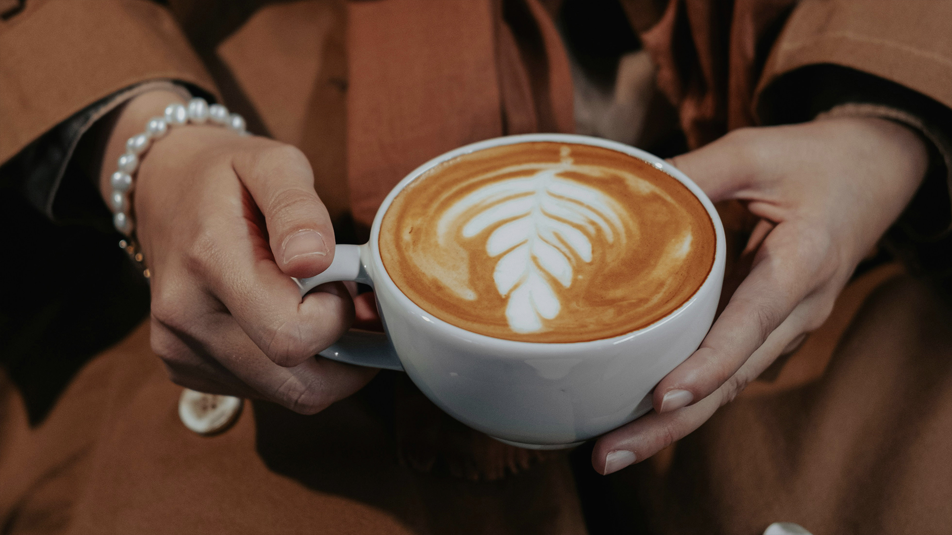 a person holding a cup of coffee