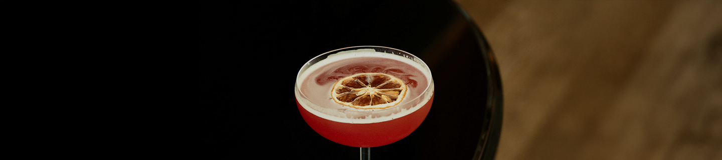 a glass with a drink and a slice of lemon