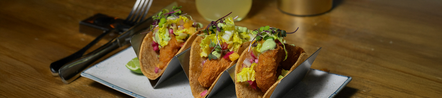 a group of tacos with vegetables and meat