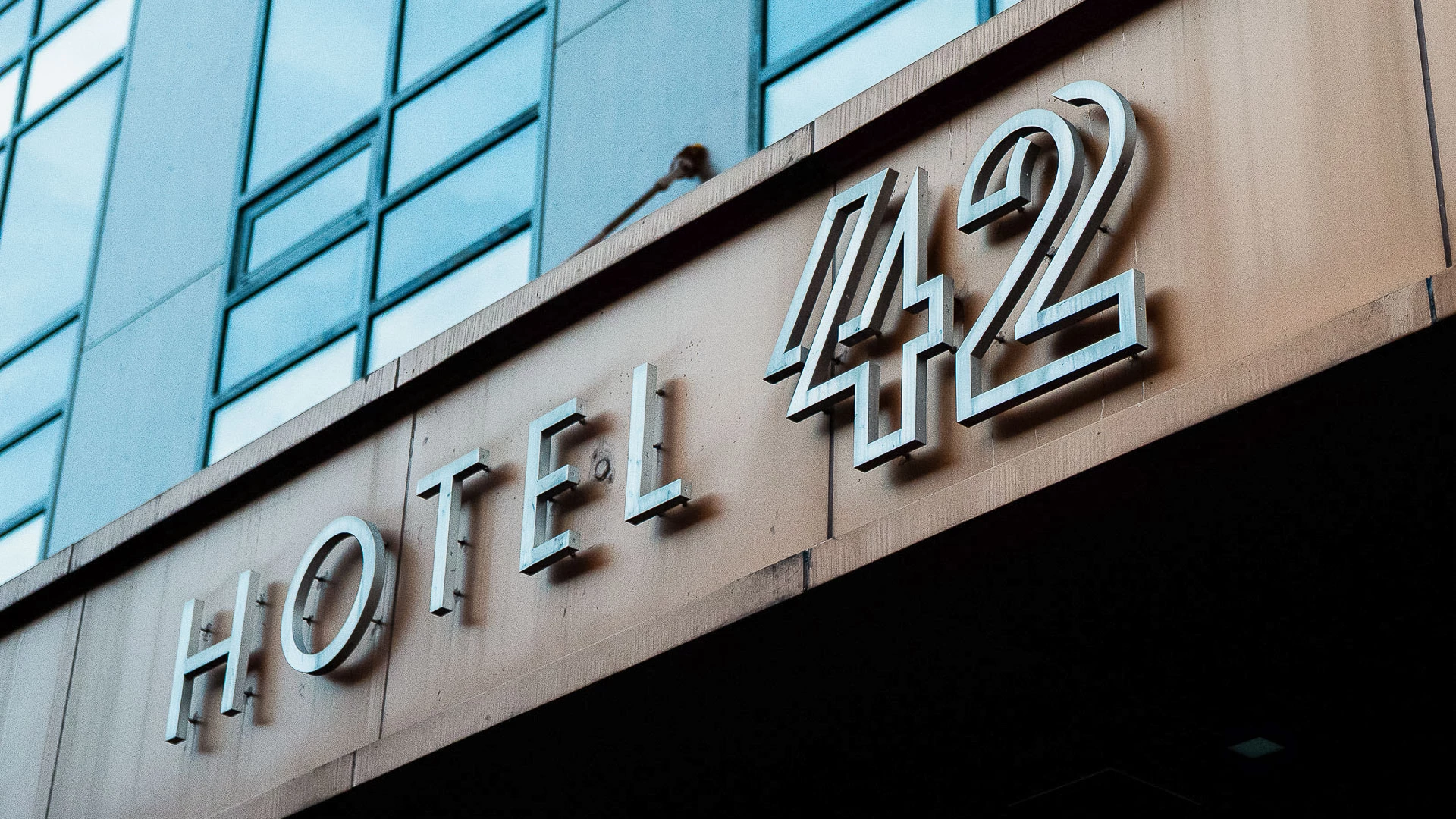 A close-up view of the Hotel 42 sign mounted on a building's facade.
