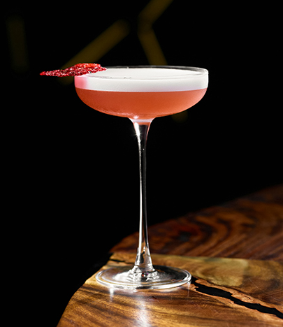 a glass with a pink drink