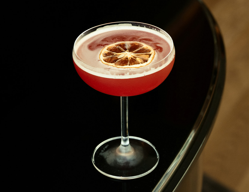 a glass with a drink and a slice of lemon